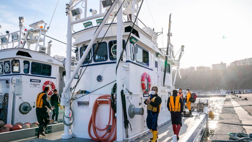 Crew members of fishing boats prepare to leave for a search operation for the missing, at a port in Shari, in northern Japan of Hokkaido Monday, April 25, 2022. Rescuers found a child of unknown condition in the early hours of Monday, as the search c
