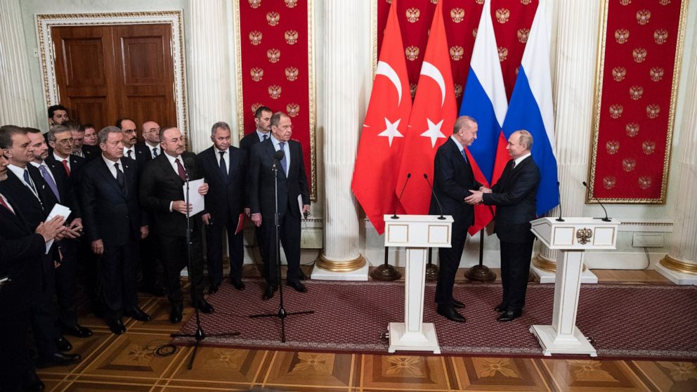 Russian President Vladimir Putin, right, and Turkish President Recep Tayyip Erdogan shake hands during a news conference after their talks in the Kremlin, in Moscow, Russia, Thursday, March 5, 2020. Russian President Vladimir Putin and his Turkish co