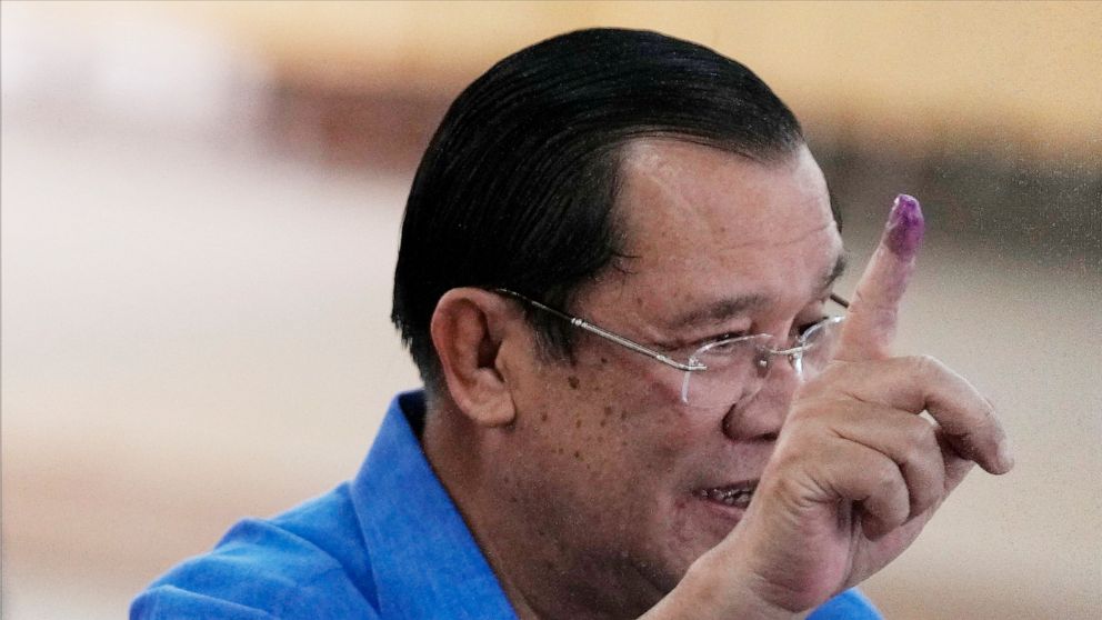 Cambodian Prime Minister Hun Sen shows off his inked finger at a polling station in Takhmua, in Kandal province, southeast of Phnom Penh, Cambodia, Sunday, June 5, 2022. Cambodians headed to the polls Sunday in local elections that are their first ch
