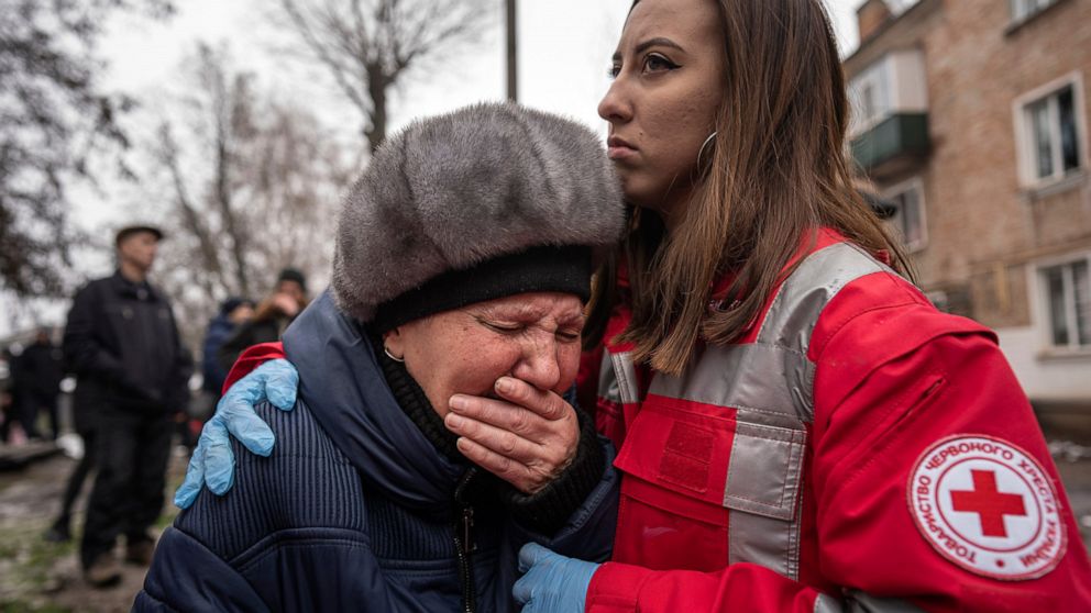 A woman cries in front of the building destroyed by a Russian attack in Kryvyi Rih, Ukraine, Friday, December 16, 2022.  Russian forces launched at least 60 missiles across Ukraine on Friday, officials said, reporting explosions in at least four.