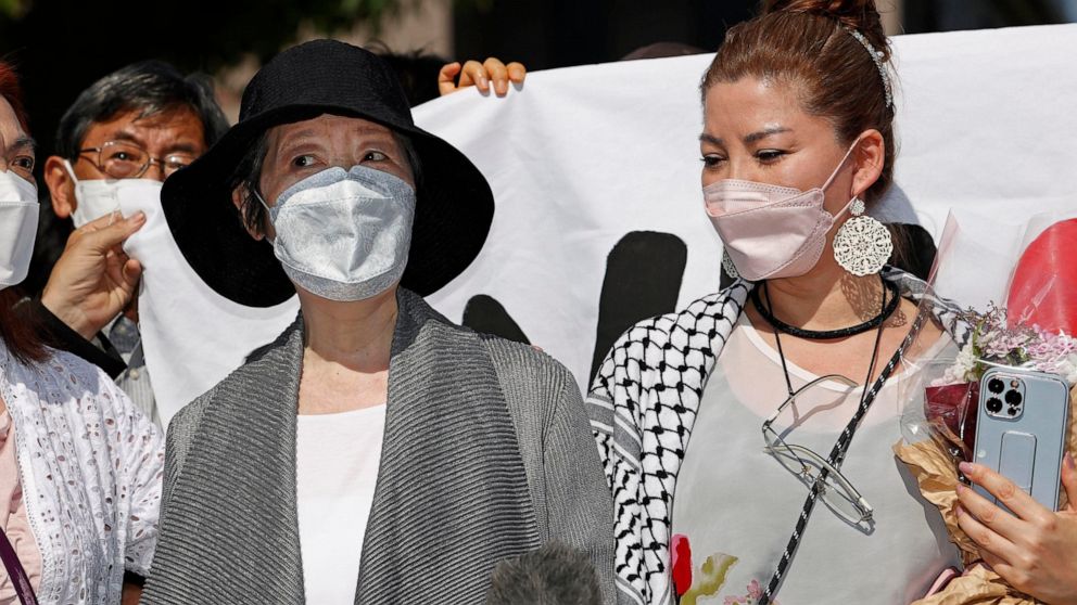 Fusako Shigenobu, left, who co-founded the terrorist group Japanese Red Army, with her daughter Mei speaks to journalists after she walked out of prison in Akishima, suburb of Tokyo Saturday, May 28, 2022. Shigenobu was released from prison Saturday 