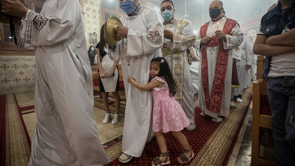 FILE - Coptic Orthodox deacon pray during Easter mass, at Holy Cross Church in Cairo, Egypt, Saturday, May 1, 2021. An Egyptian court Saturday, June 12, 2022, sentenced a man to die for the April stabbing death of a Coptic Christian priest in an atta