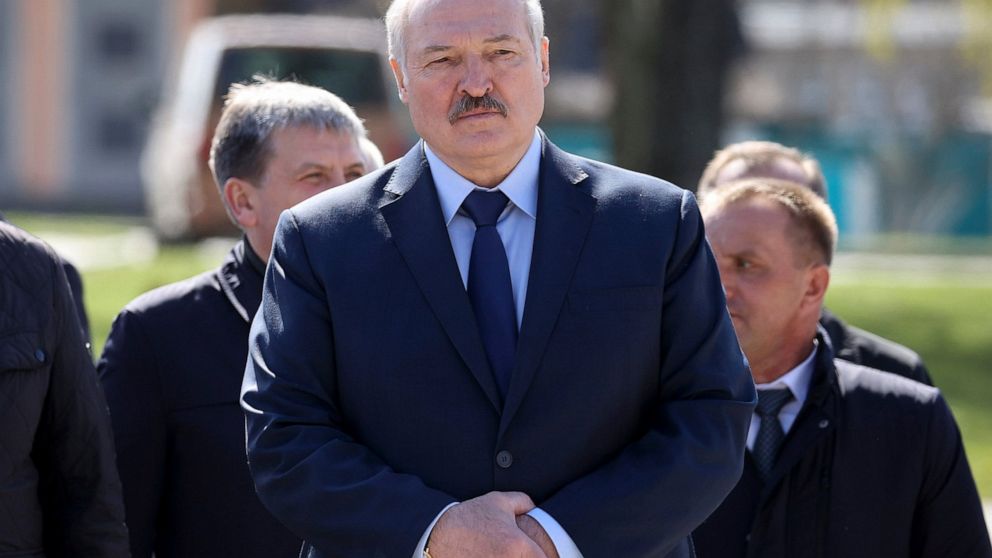 FILE - In this Monday April 26, 2021 file photo, Belarus President Alexander Lukashenko, accompanied by officials, attends a requiem rally on the occasion of the 35th anniversary of the Chernobyl disaster in the town of Bragin, some 360 km (225 miles
