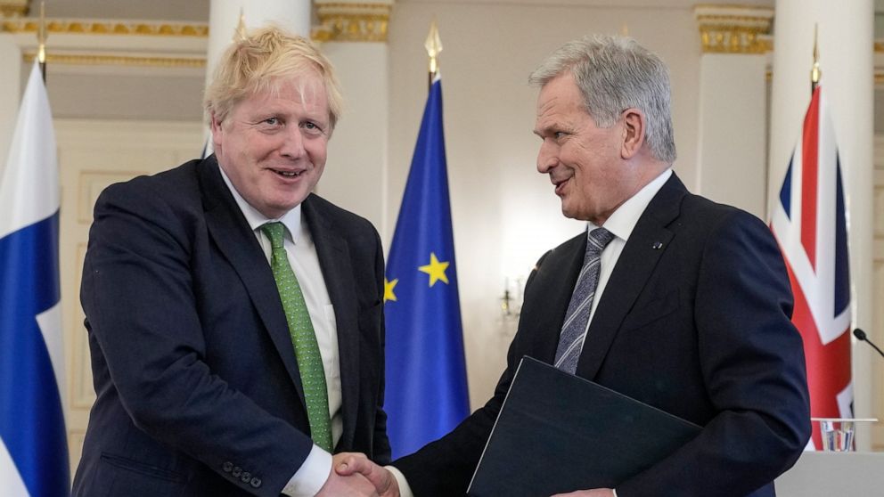 British Prime Minister Boris Johnson, left, and Finland's President Sauli Niinisto shake hands at the Presidential Palace in Helsinki, Finland, Wednesday, May 11, 2022. Britain has signed a security assurance with Sweden and its neighbor Finland, bot
