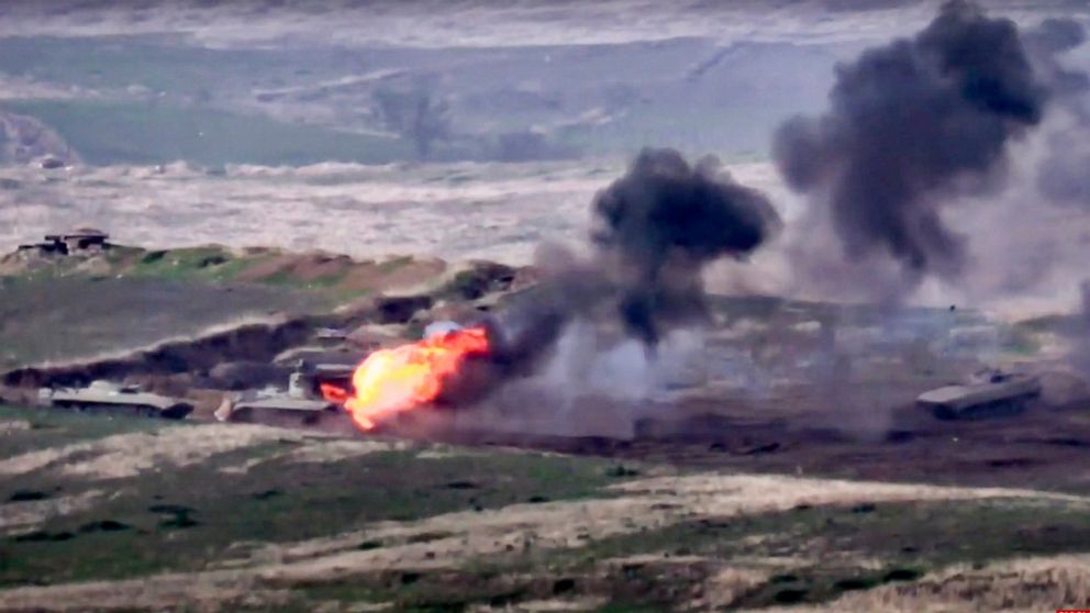In this image taken from a footage released by Armenian Defense Ministry on Sunday, Sept. 27, 2020, Armenian forces destroy Azerbaijani military vehicle at the contact line of the self-proclaimed Republic of Nagorno-Karabakh, Azerbaijan. Fighting bet