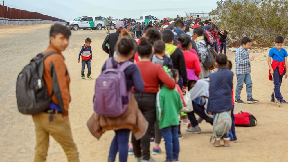 This Monday, Jan. 14, 2019 photo released by U.S. Customs and Border Protection shows some of 376 Central Americans the Border Patrol says it arrested in southwest Arizona, the vast majority of them families, who used short holes dug under a barrier 
