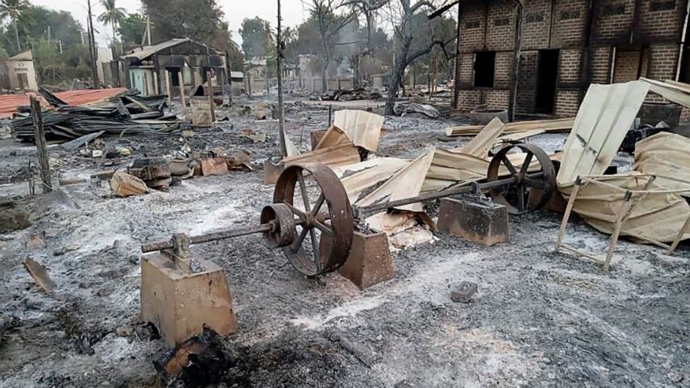 Charred homes sit in piles of ash in Mwe Tone village of Pale township in the Sagaing region, Myanmar, Tuesday, Feb. 1, 2022. Mwe Tone was one of two villages residents and Myanmar news outlets said were burned down Monday, Jan. 31, 0222, by soldiers