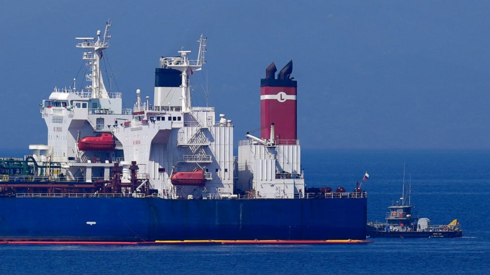 The Pegas tanker, that has recently changed its name to Lana, the blue one foreground, is seen off the port of Karystos on the Aegean Sea island of Evia, Greece, Friday, May 27, 2022. The crude oil cargo of the Iranian-flagged tanker that was stopped