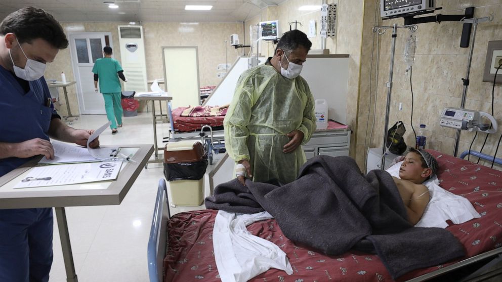 Ahmad Qassim visits his wounds son Mahmoud in a hospital in the town of Idlib, Syria, Monday, Dec. 6, 20201. A U.S. airstrike targeting an al-Qaida leader in northern Syria has wounded six of of Qassim family. The U.S. military say it conducted a str