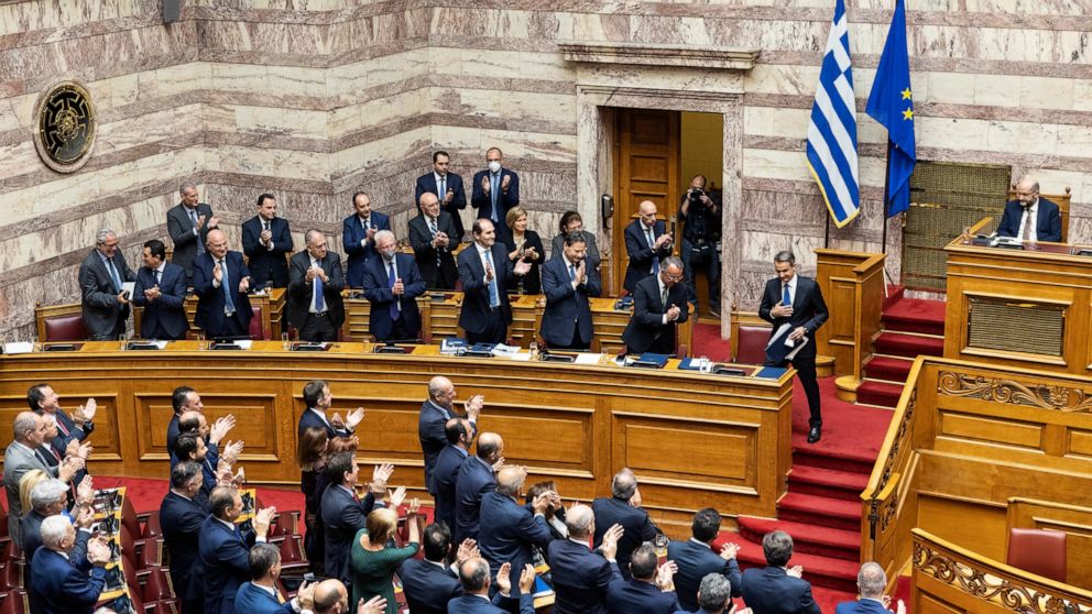 Greek Prime Minister Kyriakos Mitsotakis acknowledges applause from his lawmakers during a parliament session for the budget of 2023, in Athens, on Saturday, Dec. 17, 2022. The vote on the 2023 budget, the first in thirteen years not to be drafted un