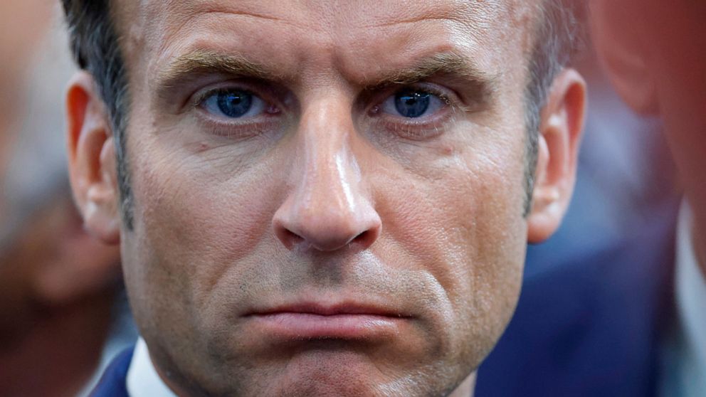 FILE - French President Emmanuel Macron looks on as he visits the Eurosatory land and airland defense and security trade fair, in Villepinte, north of Paris, June 13, 2022. Emmanuel Macron is badly weakened at home after parliamentary elections cost 