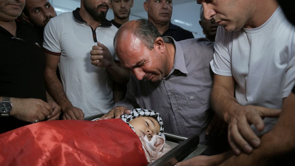 Father of 7-year-old Palestinian boy Rayan Suleiman, mourns over his son's body at a hospital in the West Bank village of Beit Jala just before his funeral Friday, Sept. 30, 2022. The U.S. State Department has called on Israel to open a "thorough" in