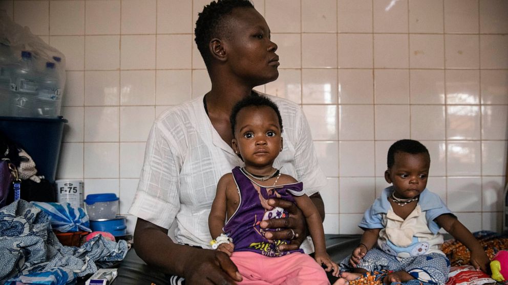 FILE- In this April 15, 2022 file photo, malnourished children wait for treatment in the pediatric department of Boulmiougou hospital in Ouagadougou, Burkina Faso. The U.N. is warning that 18 million people in Africa’s Sahel region face severe hunger