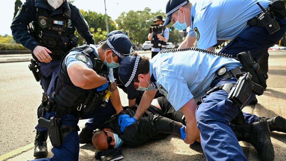 Police arrest a man during an anti-lockdown protest in Sydney, Australia, Saturday, Aug. 21, 2021. Protesters are rallying against government restrictions placed in an effort to reduce the COVID-19 outbreak. (Steven Saphore/AAP Image via AP)