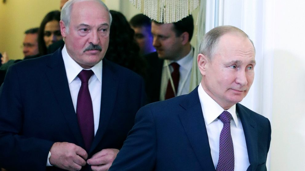 FILE In this file photo taken on Friday, Dec. 20, 2019, Russian President Vladimir Putin, right, and Belarusian President Alexander Lukashenko walk before a meeting of the Supreme Eurasian Economic Council in St. Petersburg, Russia. Russia has halted