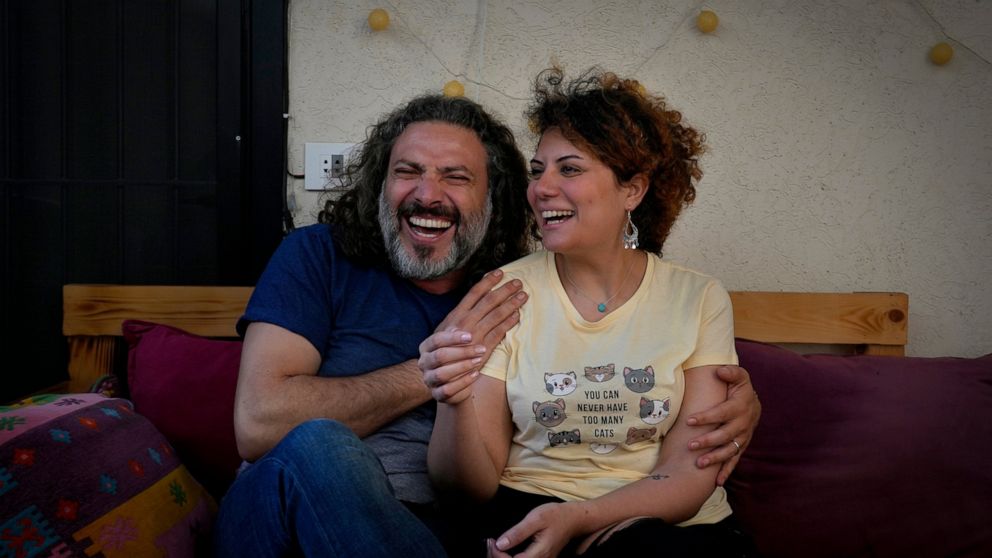 Mazen Jaber and Dona-Maria Nammour, who had a civil marriage in Cyprus earlier this year, laugh as they speak during an interview with The Associated Press at their home in Beirut, Lebanon, Friday, June 3, 2022. In Lebanon, the question of civil marr