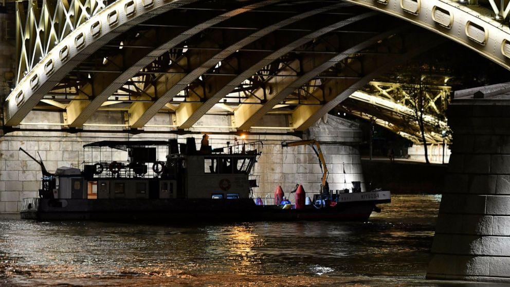 A boat taking part in the rescue operations is anchored under Margaret Bridge in Budapest, Hungary, Wednesday, June 5, 2019. A sightseeing boat carrying 33 South Korean tourists was crashed by a large river cruise ship and sank in the River Danube at