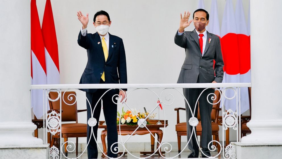 In this photo released by Indonesian Presidential Palace, Japanese Prime Minister Fumio Kishida, left, and Indonesian President Joko Widodo, right, wave during their meeting at the presidential palace in Bogor, West Java, Indonesia, Friday, April 29,