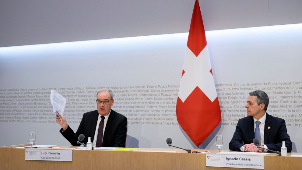 Federal Councillor Guy Parmelin, left, speaks alongside Federal President Ignazio Cassis during a Federal Council media conference on European policy and the war in Ukraine, in Bern, Switzerland, Friday, Feb. 25, 2022. Russia’s invasion of Ukraine ha