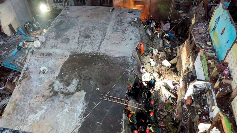 This photograph provided by India’s National Disaster Response Force (NDRF) shows rescuers at the site after a residential building collapsed in Bhiwandi in Thane district, a suburb of Mumbai, India, Monday, Sept.21, 2020. (National Disaster Response