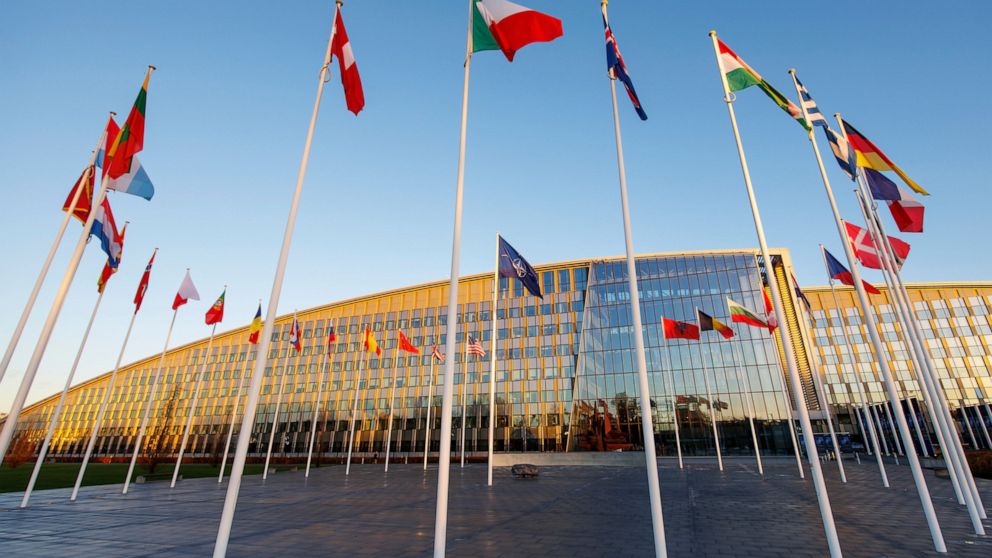 Flags of NATO members fly outside the NATO headquarters, Wednesday, Nov. 16, 2022 in Brussels. Ambassadors from the 30 NATO nations gathered for emergency talks after Poland said that a Russian-made missile fell on its territory killing two people an