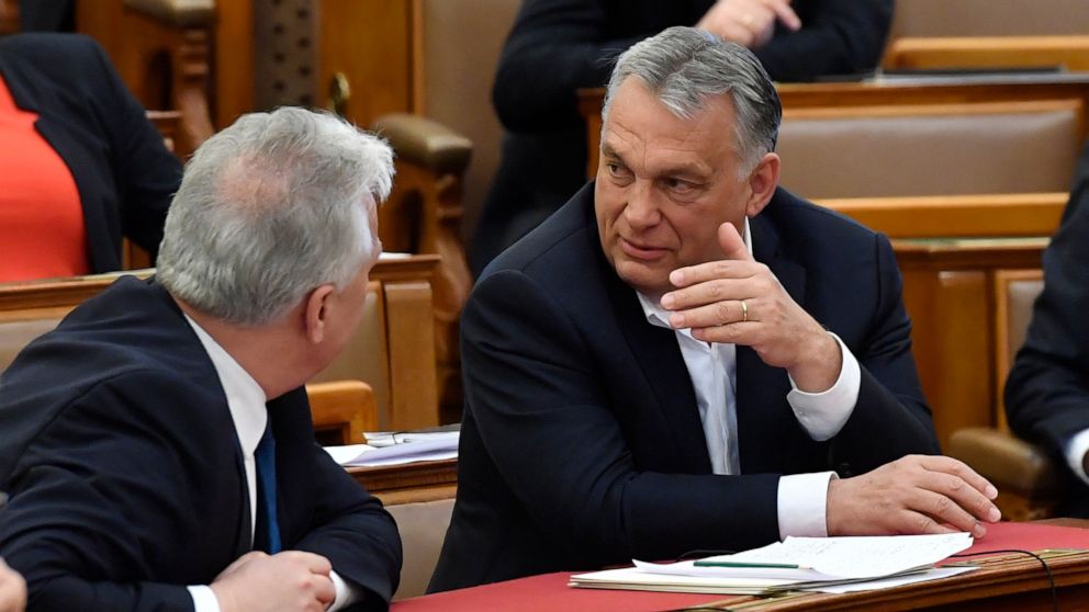 Hungarian Prime Minister Viktor Orban, right, chats with his deputy Zsolt Semjen during a plenary session of the Parliament in Budapest, Hungary, Budapest, Hungary, Monday, March 30, 2020. Hungary's parliament on Monday approved a bill giving Prime M