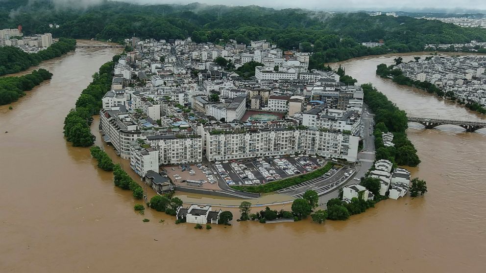 In this photo released by Xinhua News Agency, aerial photo shows flooded areas of Wuyuan County, southeastern China's Jiangxi Province Monday, June 20, 2022. Heavy rainstorms are causing major flooding and landslides in southern China. (Wang Guohong/