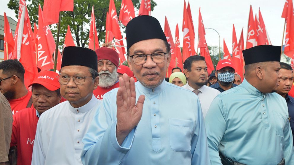 Malaysian opposition leader Anwar Ibrahim waves to his supporters as he arrives at a nomination center for the upcoming general election in Tambun, Malaysia, Saturday, Nov. 5, 2022. Malaysia's king on Thursday, Nov. 24, 2022, named Anwar as the count