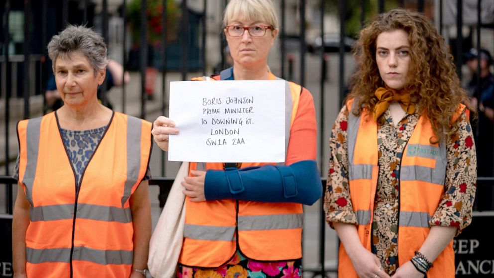 Members of Insulate Britain attempt to hand in a letter for Prime Minister Boris Johnson at 10 Downing Street, London, Thursday, Oct, 14, 2021. Environmental protesters pressuring the British government to insulate all homes within a decade as a way 