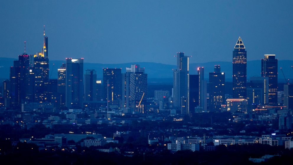 The buildings of the banking district are seen in Frankfurt, Germany, at dawn on early Sunday, May 31, 2020. (AP Photo/Michael Probst)