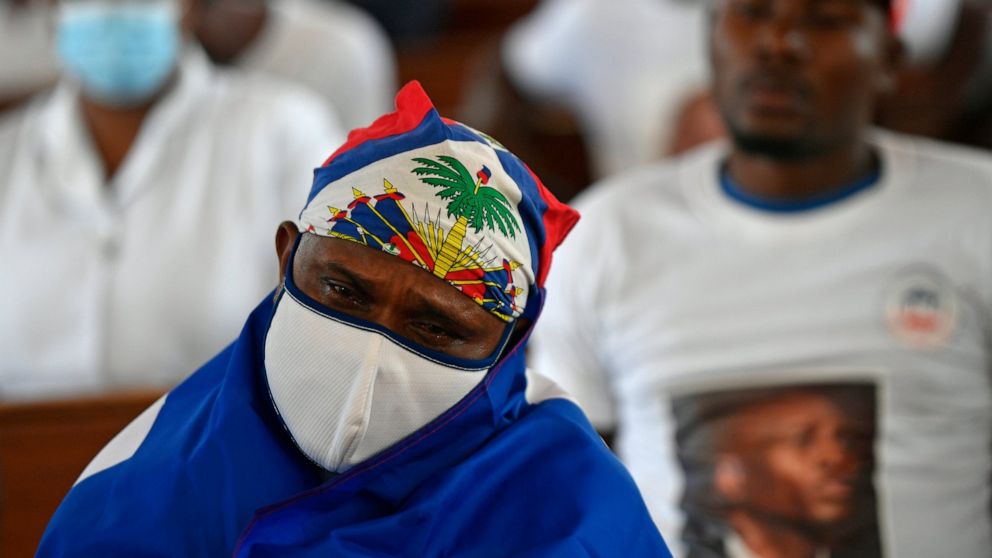 A person cries during a memorial service for assassinated President Jovenel Moïse in the Cathedral of Cap-Haitien, Haiti, Thursday, July 22, 2021. Moïse was killed in his home on July 7. (AP Photo/Matias Delacroix)