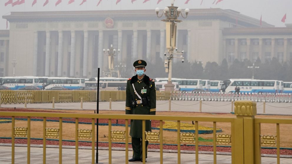 A Chinese paramilitary policeman stands watch near the Great Hall of the People where the annual National People's Congress is held in Beijing on Friday, March 5, 2021. The ruling Communist Party is aiming for economic growth over 6% as it rebounds