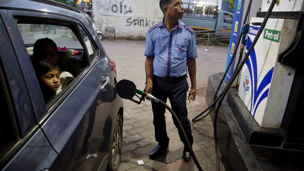 FILE - A man fills his car at a gasoline station in Gauhati, India, Sunday, Sept. 22, 2019. The state-run Indian Oil Corp. bought 3 million barrels of crude oil from Russia earlier this week to secure its energy needs, resisting Western pressure to a