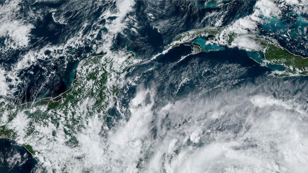 This Saturday, Oct. 8, 2022 satellite image made available by the U.S. National Oceanic and Atmospheric Administration shows Tropical Storm Julia, bottom right, at 4 p.m. EDT. Julia is gaining strength heading westward in the southern Caribbean, and 