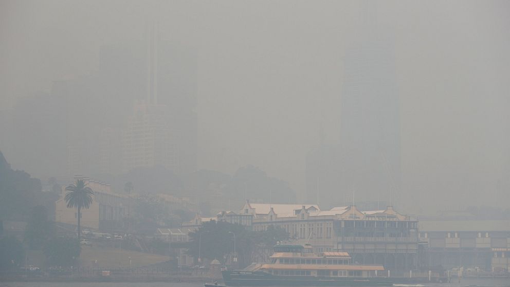 A ferry sails on the harbor as thick smoke settles in Sydney, Australia, Tuesday, Dec. 10, 2019. Hot dry conditions have brought an early start to the fire season. (AP Photo/Rick Rycroft)