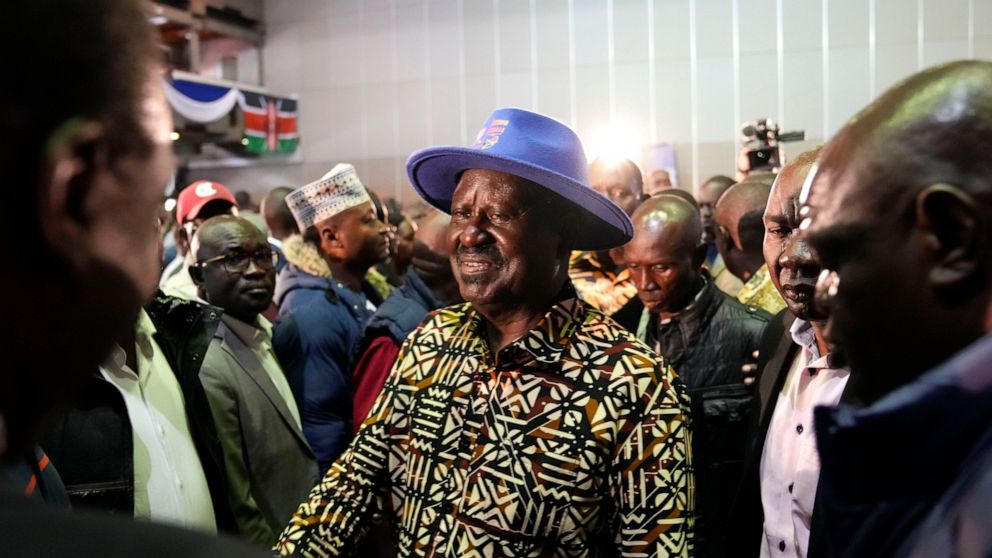Kenyan presidential candidate Raila Odinga, center, walks through the crowd during departure after delivering an address to the nation at his campaign headquarters in downtown Nairobi, Kenya, Tuesday, Aug. 16, 2022. Kenya is calm a day after Deputy P
