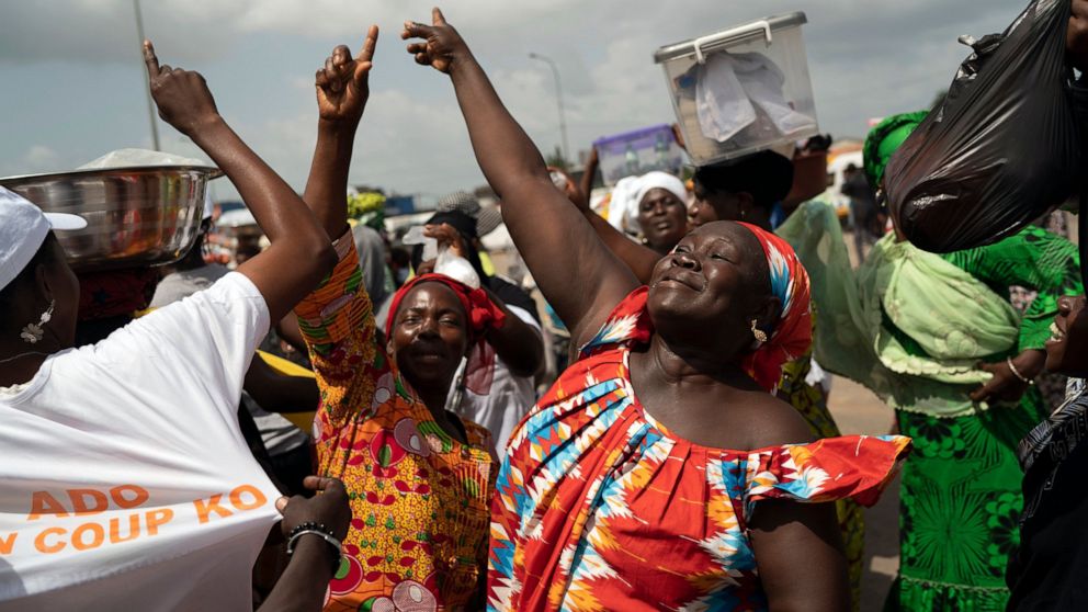 A woman celebrates the victory of Ivory Coast's President Alassane Ouattara after elections in Abidjan, Ivory Coast, Tuesday, Nov. 3, 2020. Ivory Coast's electoral commission said Tuesday that President Alassane Ouattara had overwhelmingly won a thir