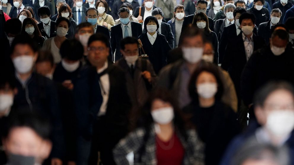 FILE - A station passageway is crowded with commuters in Tokyo, April 27, 2020. Japan’s parliament approved a hefty 29 trillion yen ($216 billion) supplementary budget Friday aimed at countering the blow to household finances from rising food and uti