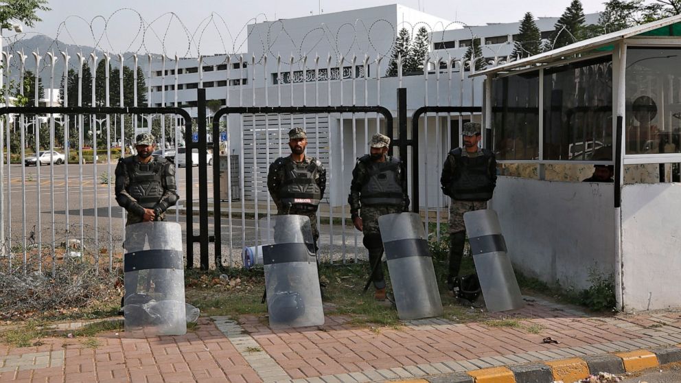 Pakistani paramilitary troops stand guard with riot gears outside the National Assembly, in Islamabad, Pakistan, Sunday, April 3, 2022. Pakistan's embattled prime minister faces a no-confidence vote in Parliament on Sunday and the opposition said it 