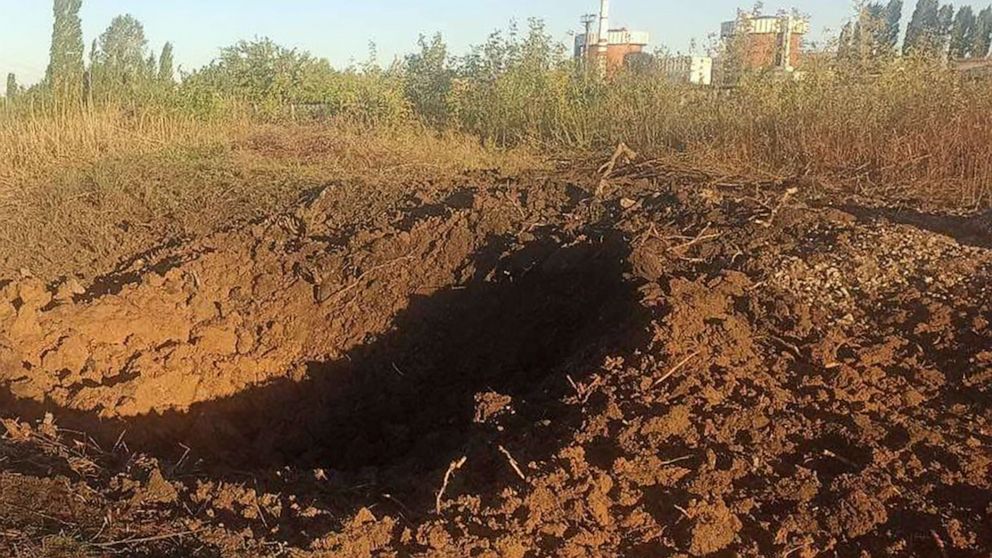 In this photo provided by the South Ukraine nuclear power plant, a crater left by a Russian rocket is seen 300 meter from the South Ukraine nuclear power plant, in the background, close to Yuzhnoukrainsk, Mykolayiv region, Ukraine, Monday, Sept. 19, 