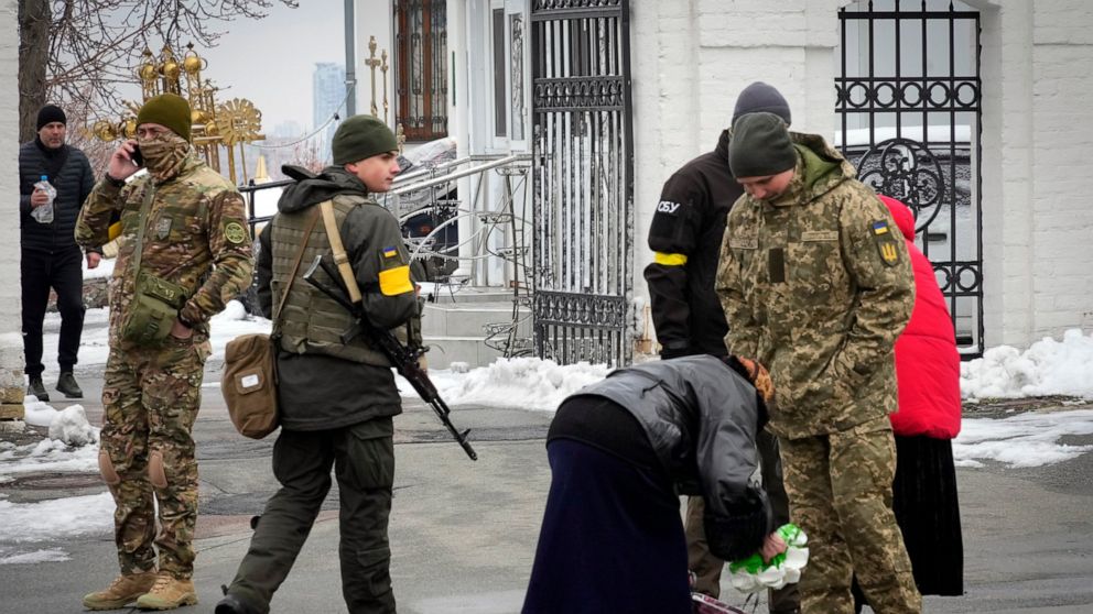 Ukraine's secret service examine belonging of a parishioner at the entrance to the Pechersk Lavra monastic complex in Kyiv, Ukraine, Tuesday, Nov. 22, 2022. Ukraine's counter-intelligence service, police officers and the country's National Guard sear