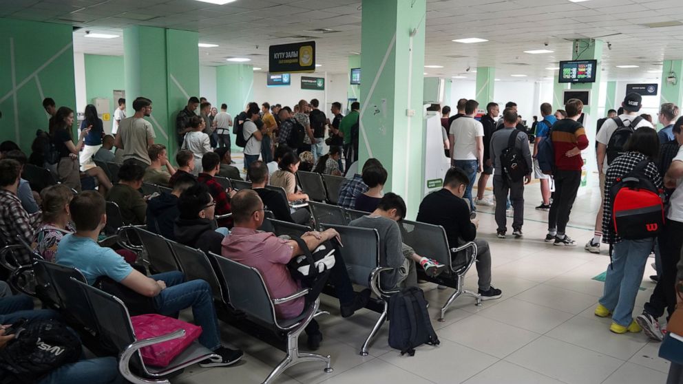 Russians wait and lineup to get Kazakhstan's INN in a public service center in Almaty, Kazakhstan, Tuesday, Sept. 27, 2022. A day after President Vladimir Putin ordered a partial mobilization to bolster his troops in Ukraine, many Russians are leavin