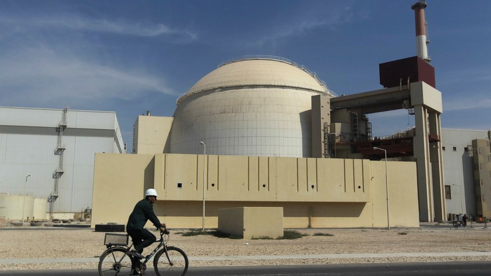 FILE - In this Oct. 26, 2010 file photo, a worker rides a bike in front of the reactor building of the Bushehr nuclear power plant, outside Bushehr, Iran. Iran’s President Hassan Rouhani is reportedly set to announce ways the Islamic Republic will re