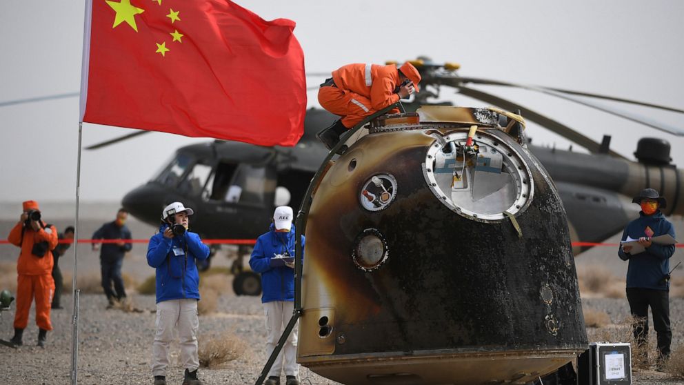 In this photo released by China's Xinhua News Agency, the return capsule of the Shenzhou-13 manned space mission is seen after landing at the Dongfeng landing site in northern China's Inner Mongolia Autonomous Region, Saturday, April 16, 2022. Three 