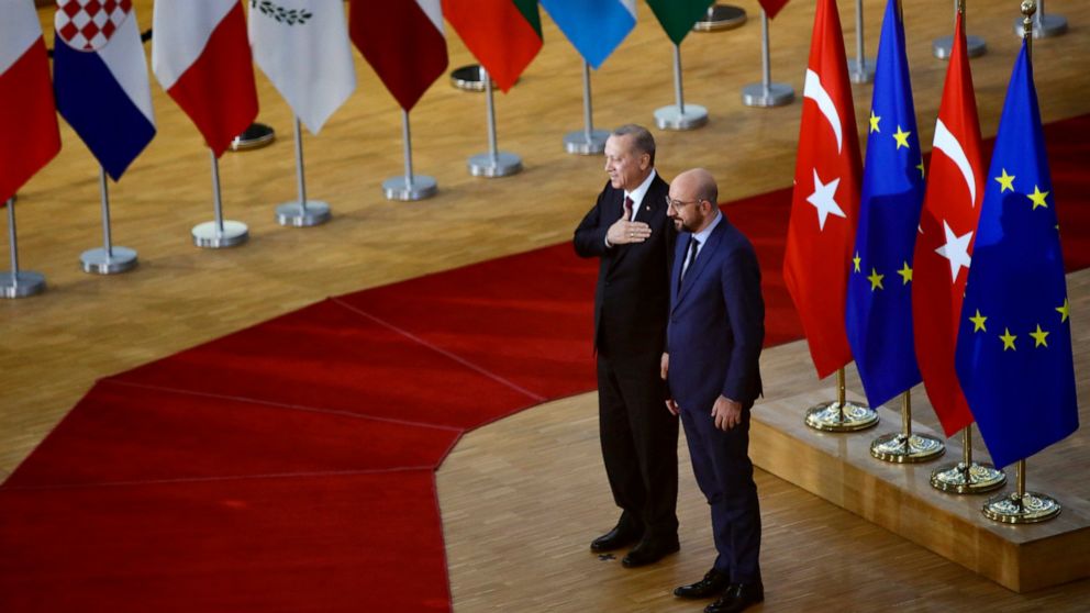 Turkish President Recep Tayyip Erdogan, left, puts his hand over his heart in a gesture of hello as he is greeted by European Council President Charles Michel prior to a meeting at the European Council building in Brussels, Monday, March 9, 2020. Tur