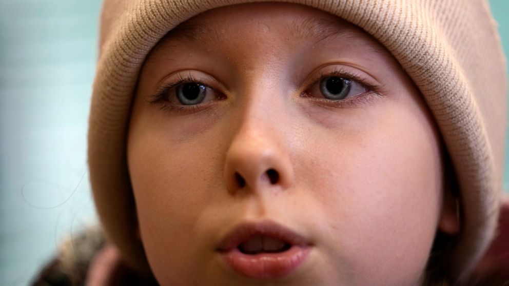 Annamaria Moslovska, a ten-year-old from Kharkiv, eastern Ukraine, speaks in a waiting room at the train station in Zahony, Hungary, Monday, March 7, 2022. After hearing bombs falling in her hometown of Kharkiv, Annamaria Maslovska left her friends, 