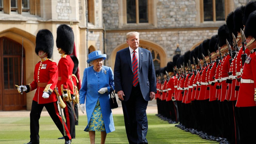 FILE - In this Friday, July 13, 2018 file photo, U.S. President Donald Trump and Britain's Queen Elizabeth inspects the Guard of Honour at Windsor Castle in Windsor, England. U.S. President Donald Trump will pay a state visit to Britain in June as a 