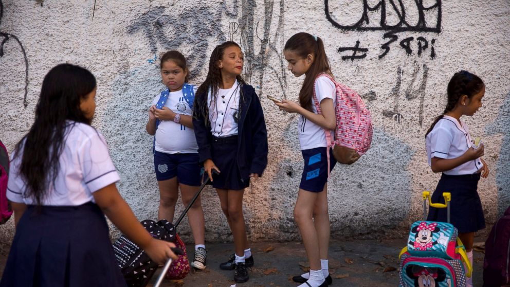 In this Feb. 4, 2019 photo, students arrive for their first day of school, in Rio de Janeiro, Brazil. Brazilian President Jair Bolsonaro is taking his anti-leftist ideological war to the country's classrooms and universities, causing angst among teac