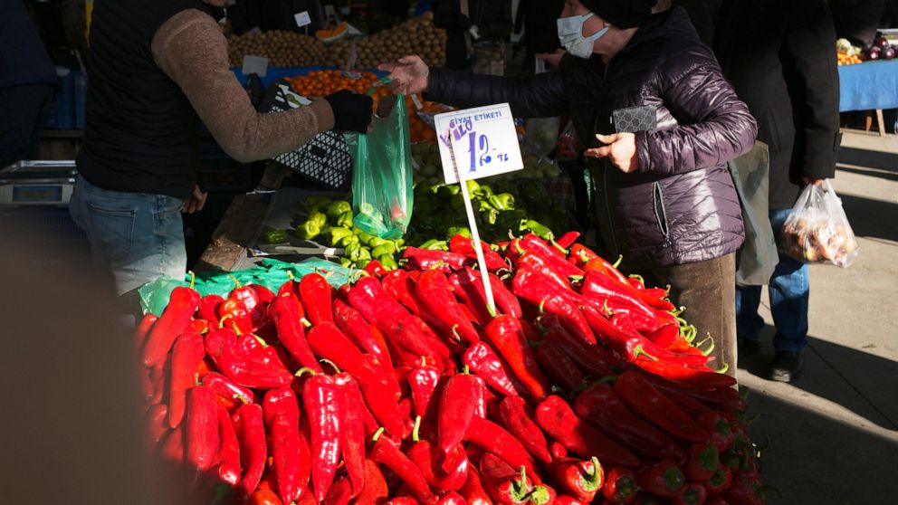 FILE - People buy vegetables at an open air market in Ankara, Turkey, on Feb. 6, 2022. The Turkish Statistical Institute said Thursday that consumer prices rose 54.44% in February compared with a year ago. The highest yearly price increase was in tra