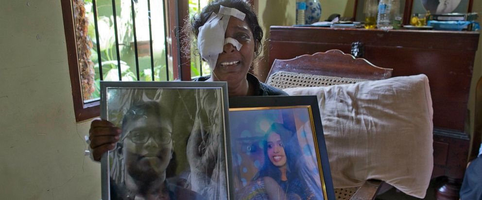 Anusha Kumari holds portraits of her daughter Sajini Venura Dulakshi and son Vimukthi Tharidu Appuhami, both victims of Easter Sundays bomb blast in Negombo, Sri Lanka, Wednesday, April 24, 2019. Kumari, 43, was left childless and a widow when suici